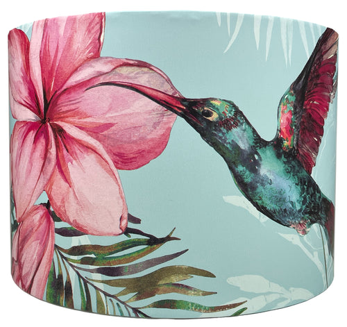 Tropical hummingbird lampshade featuring pink floral and palm leaf design on light blue background.