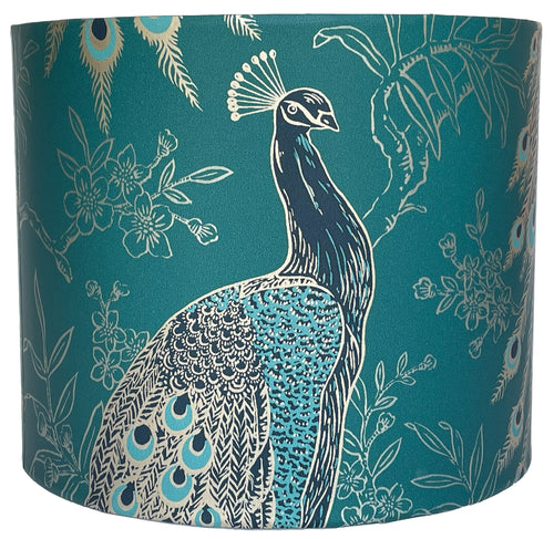 Peacock lampshade featuring metallic gold peacock design on deep teal background.