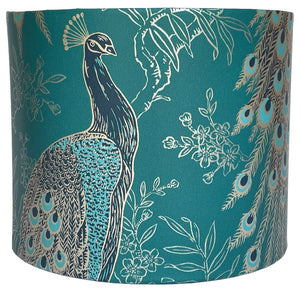 Elegant lampshade with exotic peacock motif in shimmering gold accents.