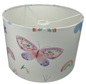 Nursery lampshade adorned with pastel butterflies and rainbows, perfect for a dreamy atmosphere.