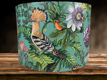 Load image into Gallery viewer, Teal background lampshade with vibrant tropical bird and foliage design.