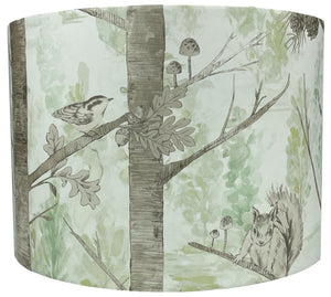 Woodland animal lampshade featuring squirrels and birds on metallic-effect tree branches.